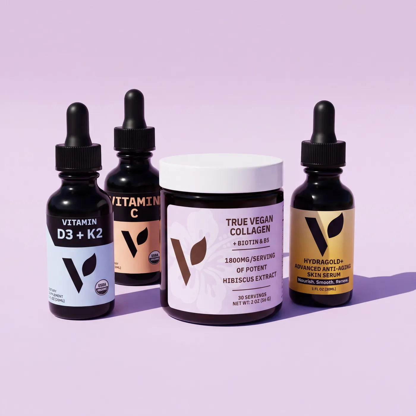 The four products in routine order: Vitamin D3 + K2, Organic Vitamin C, True Vegan Collagen and Hydragold+ serum on a lavender backdrop